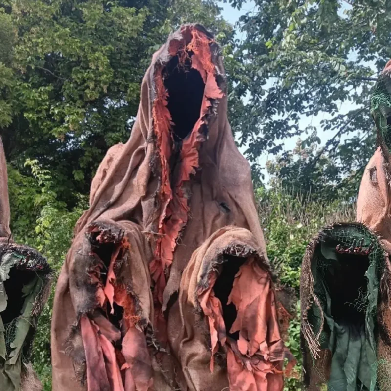 Halloween ghostly puppets posing in a woodland setting.